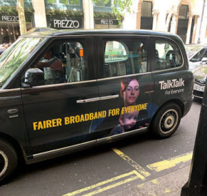 taxi with a banner describing the effort for fairer broadband.